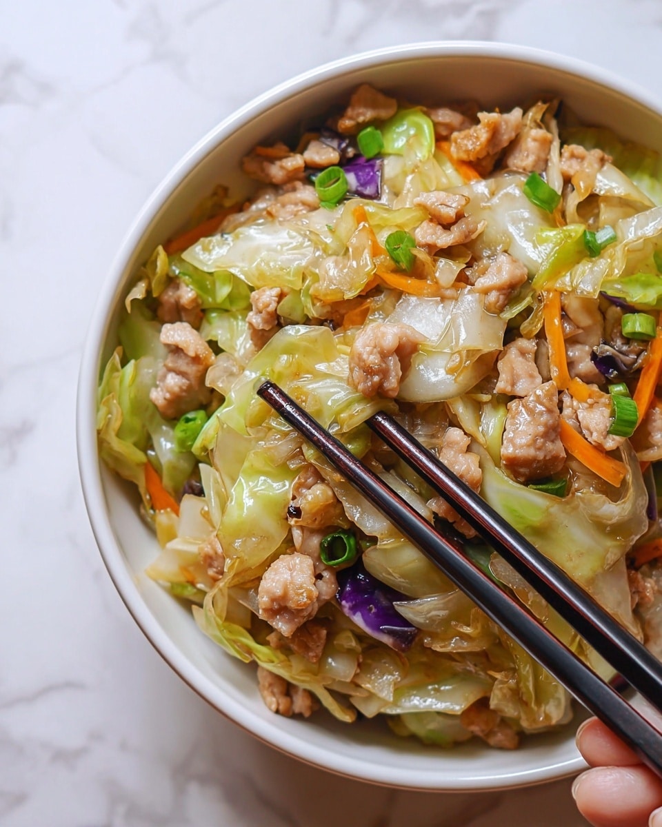 The image shows a close-up of a white bowl filled with stir-fried vegetables and small pieces of cooked meat. The dish has three main layers: the bottom layer consists of light green and translucent cabbage pieces with a slightly glossy texture; the middle layer includes small chunks of browned meat with a light pinkish-brown color; the top layer has chopped green onions, small bits of orange carrots, and some purple cabbage, adding bright color contrast. A pair of dark chopsticks are held by a woman's hand picking up some food from the bowl. The background is a white marbled texture. Photo taken with an iphone --ar 4:5 --v 7