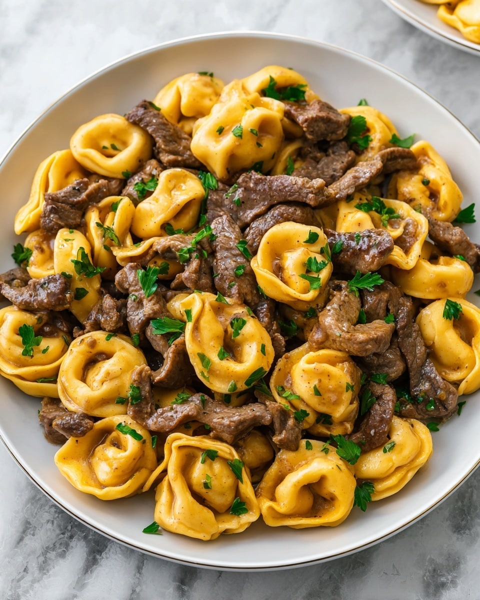 The dish shows a close-up of a single-layer pasta meal served in a white bowl, placed on a white marbled surface with a blurred dark blue cloth in the background. The pasta is yellow and smooth, with large shell shapes, covered with browned, textured ground beef pieces. There is a layer of melted white cheese spread unevenly over the top, with small green herb flakes sprinkled throughout the dish. The textures are rich, with the beef looking tender and the cheese gooey and stretchy. Photo taken with an iphone --ar 4:5 --v 7